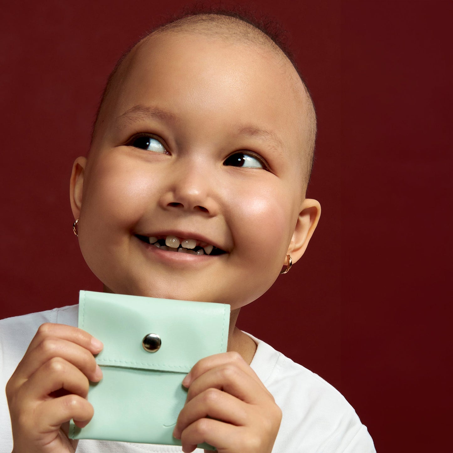 TWISTED LEUCAN HUGGIES EARRINGS.